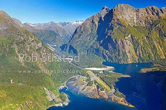 Milford Sound township aerial photo showing Bowen Falls left, Freshwater Basin, Airport, with Cleddau River and Deepwater Basin beyond, and Sheerdown Peak (1878m), Milford Sound, Fiordland National Park, Southland District, Southland Region, New Zealand (NZ)