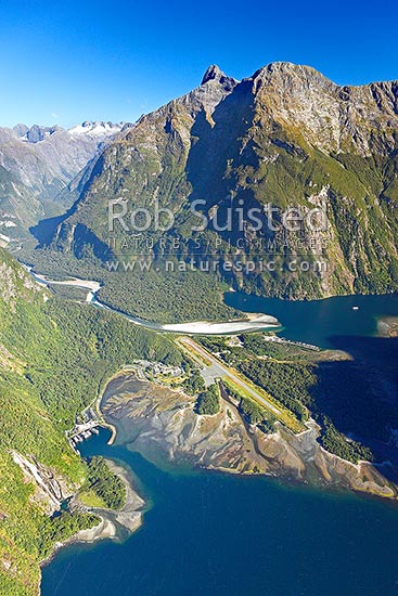 Milford Sound township aerial photo showing Bowen Falls left, Freshwater Basin, Airport, with Cleddau River and Deepwater Basin beyond, and Sheerdown Peak (1878m), Milford Sound, Fiordland National Park, Southland District, Southland Region, New Zealand (NZ)